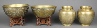A pair of circular Chinese engraved gilt metal bowls with landscape decoration 4"h x 8" diam. raised on pierced wooden stands together with a pair of Chinese gilt metal vases decorated dragons with seal mark 5" 