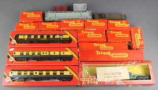 Ten items of Triang OO rolling stock comprising R214 ore wagon, R.11 goods van, R.16 ER brake van, R.13 coal truck, R.19 tarpaulin load van, R.14 fish van, R.13 goods wagon with drop sides, R.12 Shell BP petrol tanker wagon, R.19 Garbel drum wagon. R.118 Bogie rail wagon, R134 double car blue and yellow, R341 searchlight wagon, all boxed, together with 3 O gauge carriages - R229 Lucille Pullman car, R931 GWR coach composite and R932 GWR coach