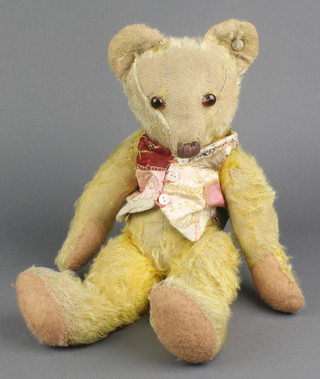 A yellow teddybear with articulated limbs 17",  balding in places 