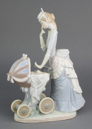 A Lladro figure of a lady with a child in a pram 4938 13" 