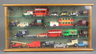 24 various model cars contained in an oak and perspex hanging display cabinet
