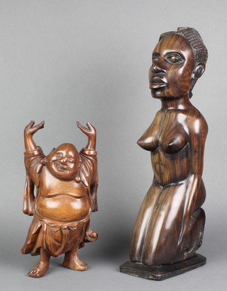 A carved Chinese hardwood figure of a standing Buddha with raised arms 10" and an African carved hardwood figure of a kneeling lady 17" (head drilled possibly for a lamp) 