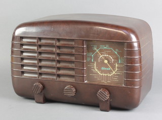 A Strad portable radio contained in a brown arched Bakelite case, the reverse marked made by R M Electrical Ltd Gateshead 11 