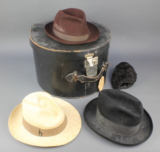A fibre hat box containing a gentleman's Homburg hat by Dunn's, a brown trilby by Lincoln Bennett, various fur collars