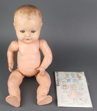 Armand Marseille, a composition headed doll with sleep eyes, open mouth and articulated limbs, the head incised AM Germany 549/13 1/2K 19" together with a Butterick printed pattern 