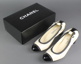 Chanel, a pair of lady's white and black patent pump shoes, size 39, boxed 
