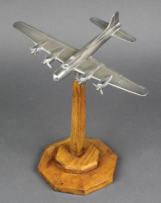 A chrome model of a Flying Fortress, raised on an oak base 8" 