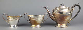 A Harrods Arts & Crafts style silver plated 3 piece tea set with ebony mounts