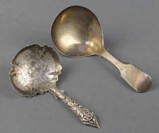 A Georgian silver caddy spoon of plain form 1816, 1 other with rubbed marks