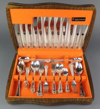 An oak canteen containing a quantity of silver plated cutlery 

