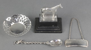 A silver model of a horse on an ebony socle London 1932 3", a spirit label, dish and spoon 