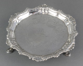 An Irish Georgian silver card tray with shell and gadroon rim, chased with flowers and birds enclosing an armorial, on pad feet, rubbed marks, 234 grams, 6" 