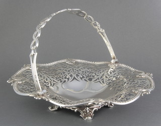 A Victorian silver swing handled basket with pierced decoration on scrolled feet London 1900, 662 grams, 10 1/2" 