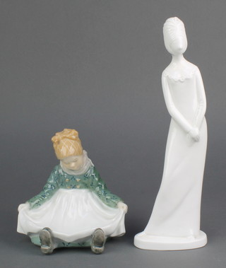 A Royal Copenhagen figure of a seated girl with out stretched apron 1315 5" together with a Spode white glazed figure Priscilla 10" 