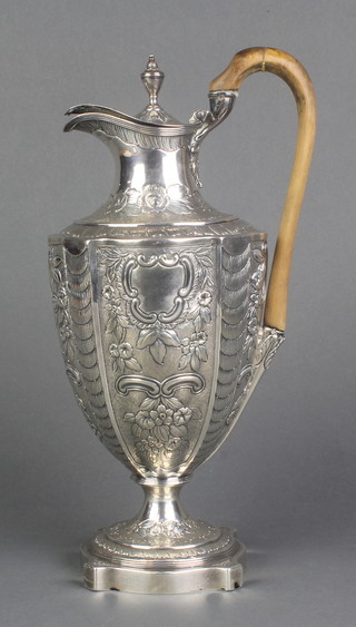 A Georgian silver ewer of classical form with repousse scroll and floral decoration and with fruitwood handle, rubbed marks, gross 714 grams 12" 