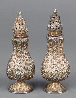 A pair of Indian repousse silver condiments decorated with flowers, 152 grams