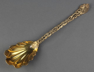 A Victorian silver gilt cast serving spoon with shell bowl and vinous handle, maker Frances Higgins II London 1877, 134 grams 