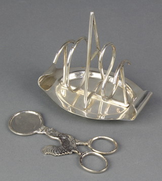 An art deco silver plated novelty toast rack, spelling toast together with a plated egg decapitator