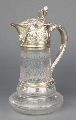 A mid Victorian silver mounted claret jug, the lid with lion finial,having floral and mask decoration, the rustic handle to the body with etched geometric decoration 10", London 1863 