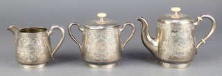 An early 20th Century Russian silver bachelor's tea set with chased Greek key pattern and scroll decoration with engraved cartouche having ivory mounts 608 grams