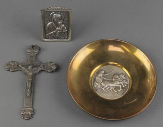 A brass dish set with a silver medallion, a cross and easel icon