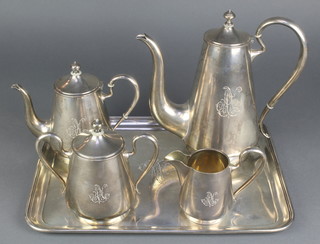 A Russian silver 5 piece tea and coffee set with chased monogram comprising coffee pot, tea pot, milk jug, lidded sugar bowl and a rounded rectangular tray, having ivory mounts gross 2495 grams 