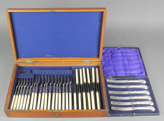 A cased set of 6 butter knives with pistol butt handles, a mahogany canteen containing a quantity of plated cutlery 