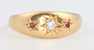 An 18ct yellow gold gypsy set diamond and ruby ring, size P 