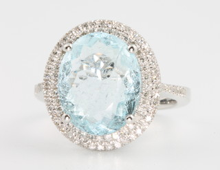 A 14ct white gold aquamarine and diamond ring, the centre stone approx 5.45ct surrounded by brilliant cut diamonds approx. 0.6ct size L 1/2