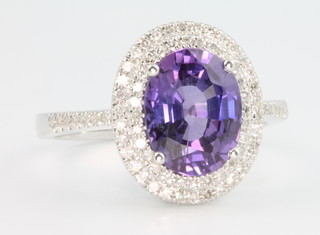 A 14ct white gold purple sapphire and diamond cluster ring, the centre stone approx. 3.25ct surrounded by brilliant cut diamonds approx 0.5ct, size W 