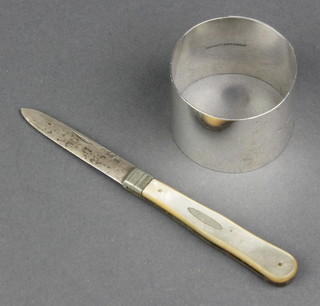 A silver napkin ring Birmingham 1912 and a silver and mother of pearl fruit knife