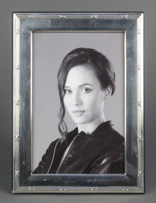 A rectangular silver photograph frame 7 1/2" x 5 1/2" 