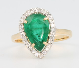 An 18ct white gold pear shaped emerald and diamond ring, the centre stone approx 2.8ct surrounded by brilliant cut diamonds approx. 0.3ct size N 1/2