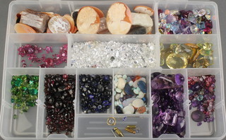 A box of loose stones and cameos including rubies, emeralds, amethysts, citrines, quartz etc 