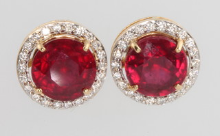 A pair of ruby and diamond cluster ear studs in a yellow gold mount, the rubies approx. 5.5ct surrounded by brilliant cut diamonds approx. 0.32ct 