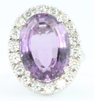A white gold cocktail ring, the oval amethyst surrounded by brilliant cut diamonds approx 1.9ct, size N