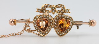 A Victorian yellow gold citrine and seed pearl double heart bar brooch 