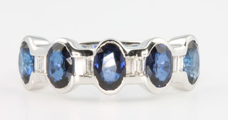 An 18ct white gold sapphire and diamond 5 stone ring, the oval cut sapphires approx. 2.92ct, the baguette cut diamonds approx 0.3ct, size N