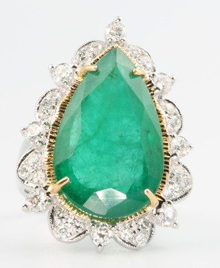 A 14ct white gold pear cut emerald and diamond ring, the centre stone approx. 15.5ct surrounded by diamonds approx 1.12ct, size N 