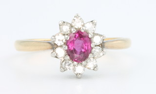 An 18ct yellow gold ruby and diamond cluster ring, size M 