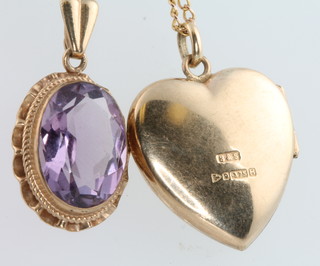 A yellow gold chain with a ditto amethyst pendant and a 9ct yellow gold heart shaped locket and chain 