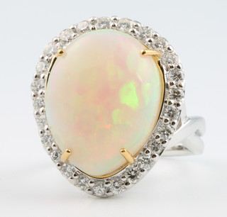 An 18ct white gold pear cut opal and diamond ring, the centre stone approx 10.6ct surrounded by brilliant cut diamonds approx 1.8ct, size N 1/2