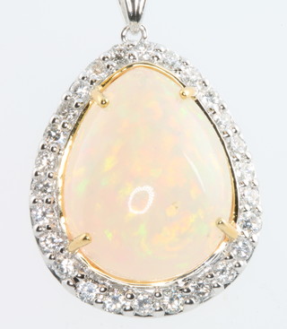 An 18ct white gold pear shaped opal and diamond pendant the centre stone approx. 8.96ct surrounded by brilliant cut diamonds approx. 0.86ct 