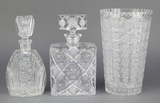 An Art Deco style spirit decanter 10", a flattened square shaped ditto 10" and a tapered cylindrical cut glass vase 11" 