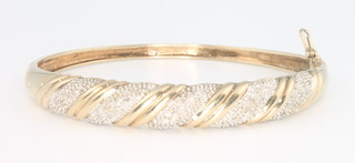A 9ct yellow gold diamond set bangle, 14 grams 