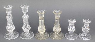 A pair of cut glass candlesticks with baluster stems 8 1/2", a ditto pair 7" and a pair of dwarf ditto 5" 