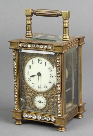 A 19th Century French 8 day carriage alarm clock with circular enamelled dial, Arabic numerals and alarm dial, contained in a shaped gilt metal and jewel studded case 4 1/2"h x 3"w x 3 1/2"d 
