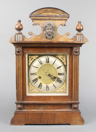 Hamburg American Clock Company, a 14 day striking bracket clock with gilt dial and silvered chapter ring, contained in a carved walnut case 