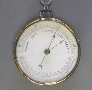 An Edwardian aneroid barometer with paper dial contained in a circular gilt metal case 4 1/2" 