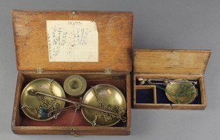 A pair of 18th/19th Century polished steel and brass gold scales in an oak case, ditto larger pair and 4 graduated troy cup weights 